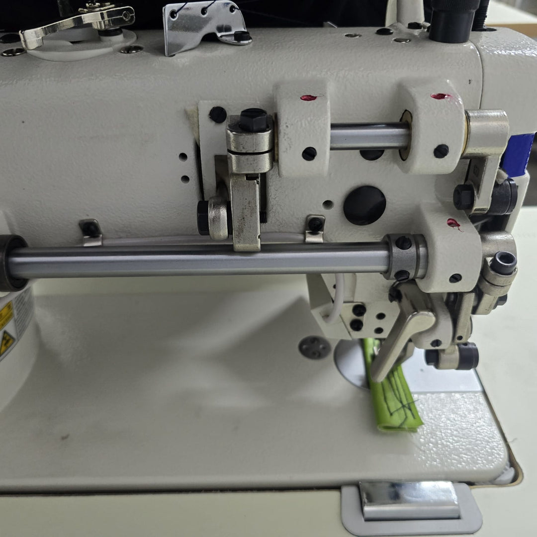Close-up of a sewing machine mechanism on a white background